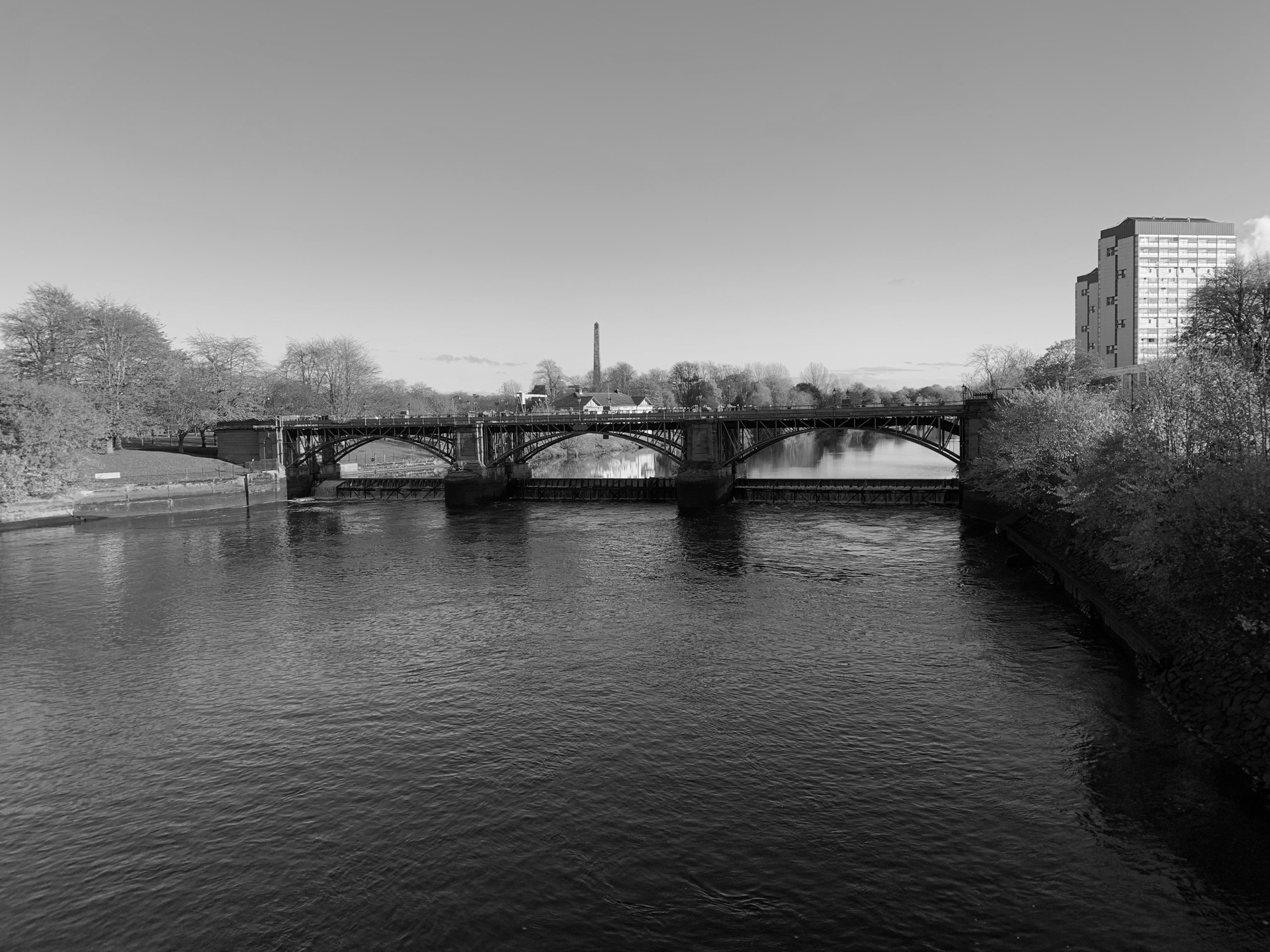 Black and white image of a bridge over water